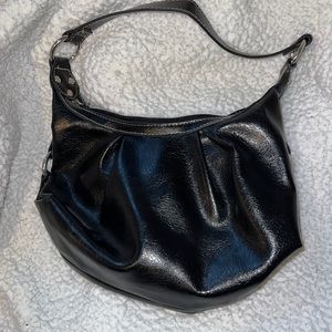 A black shoulder purse with silver accents.